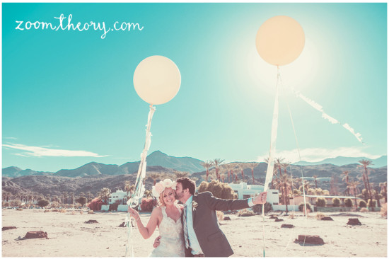 Newlyweds celebrate with balloons in desert wedding photo
