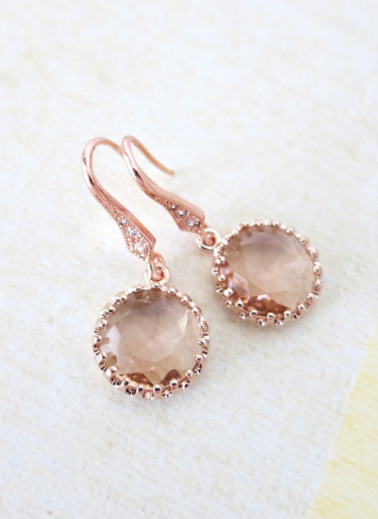 Rose gold crystal drop earrings on a white background