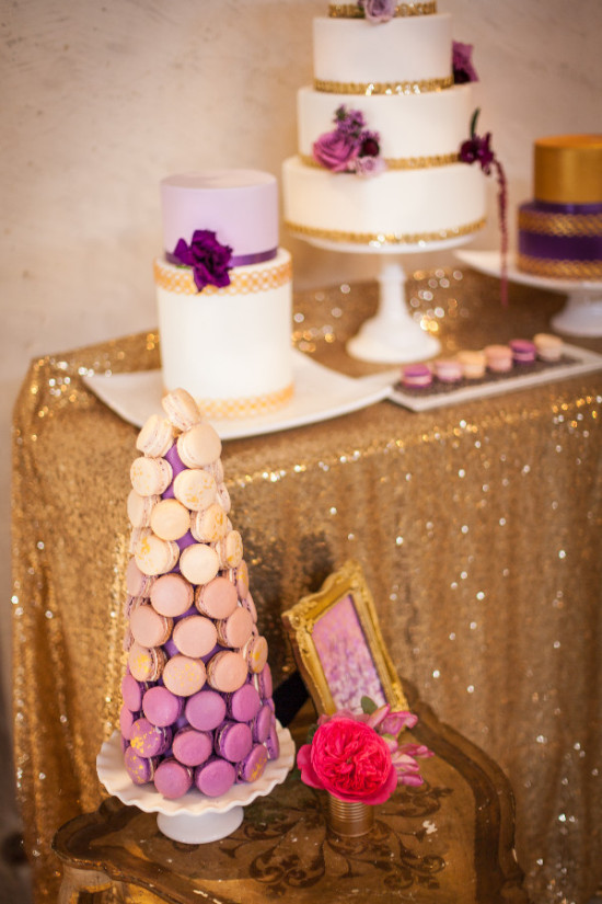 Elegant wedding cakes and macarons on a shimmering golden table