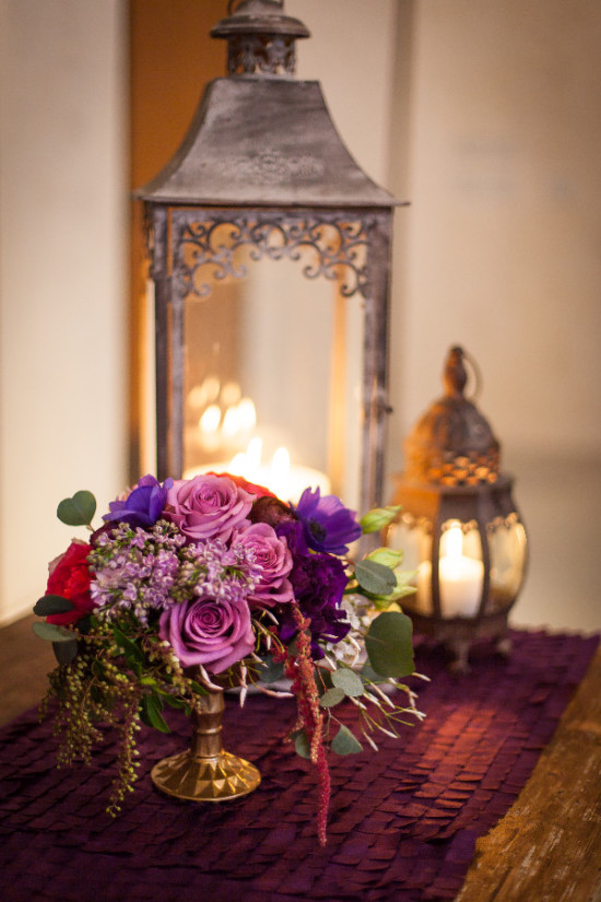 Elegant floral arrangement with lanterns and candles on display