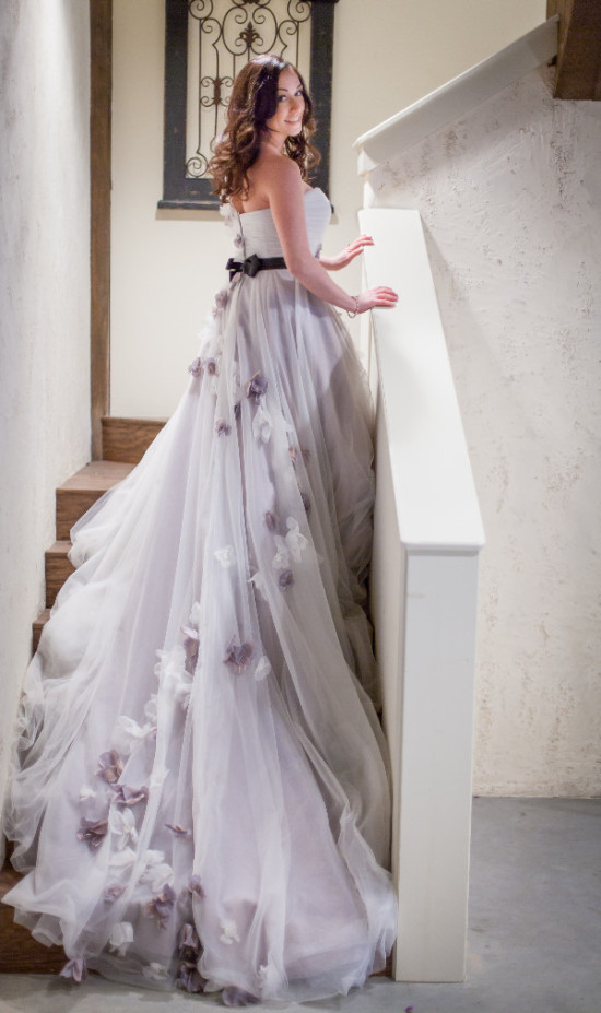 Elegant woman in a floral wedding dress on stairs