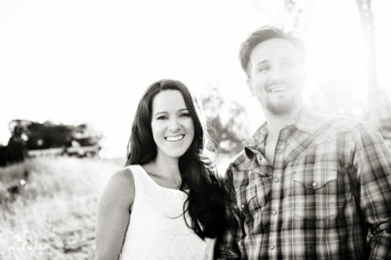 Happy couple smiling outdoors in black and white photo
