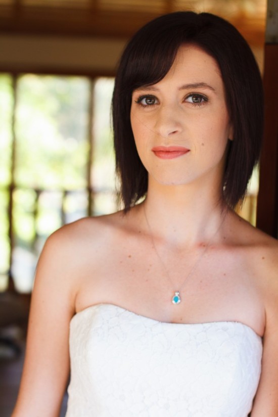 Elegant woman wearing a white dress and a turquoise necklace