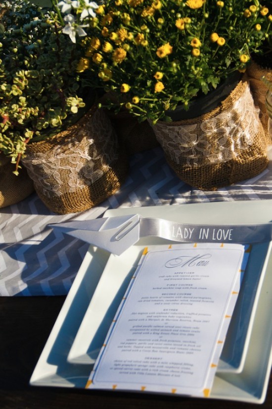 Wedding table decor with flowers, menu, and Lady in Love ribbon