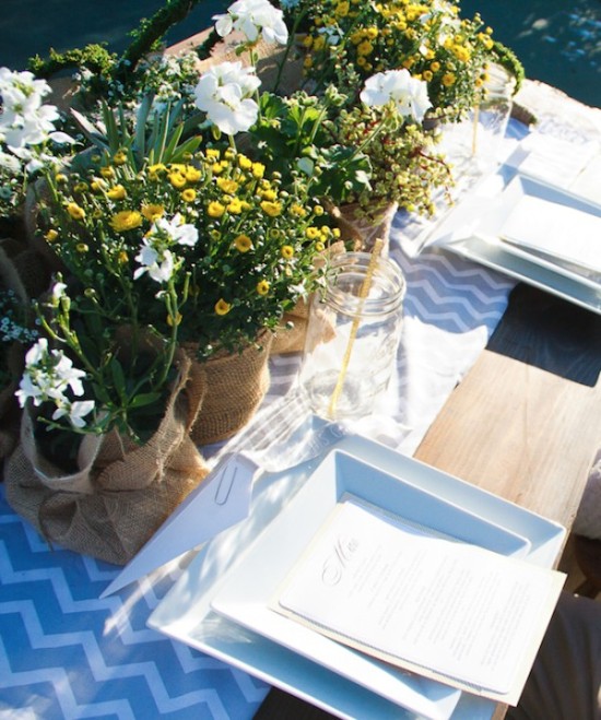 Rustic outdoor table setting with flowers and white plates