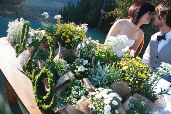 Romantic wedding decor with floral arrangements and kissing couple