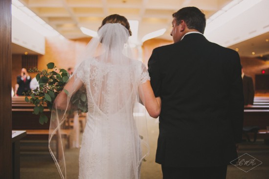 Bride walks down the aisle with her father at wedding ceremony