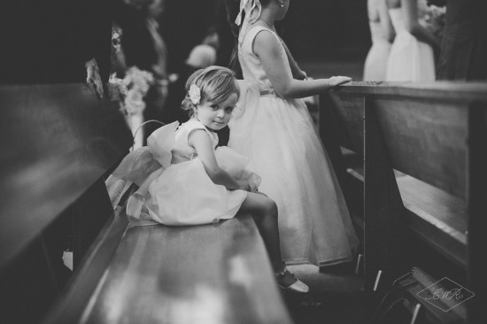 Adorable flower girl at a wedding, looking at the camera