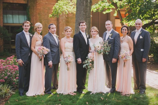 Wedding party poses happily outdoors with lovely light