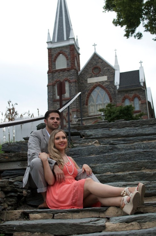 Couple posing on steps in front of a church for a photo shoot