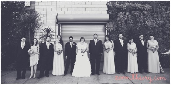 Monochrome wedding party with bride and groom posing