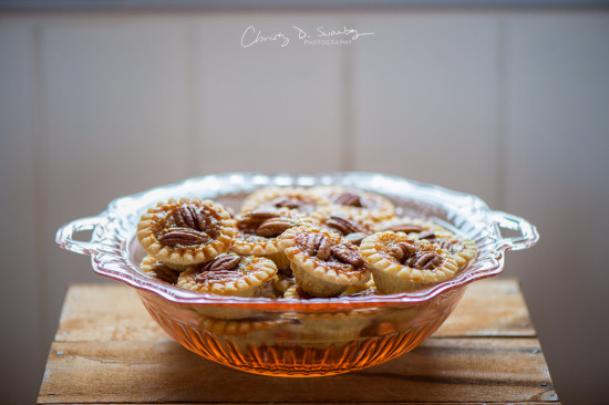 Pecan pies in a glass bowl on a wooden rustic table