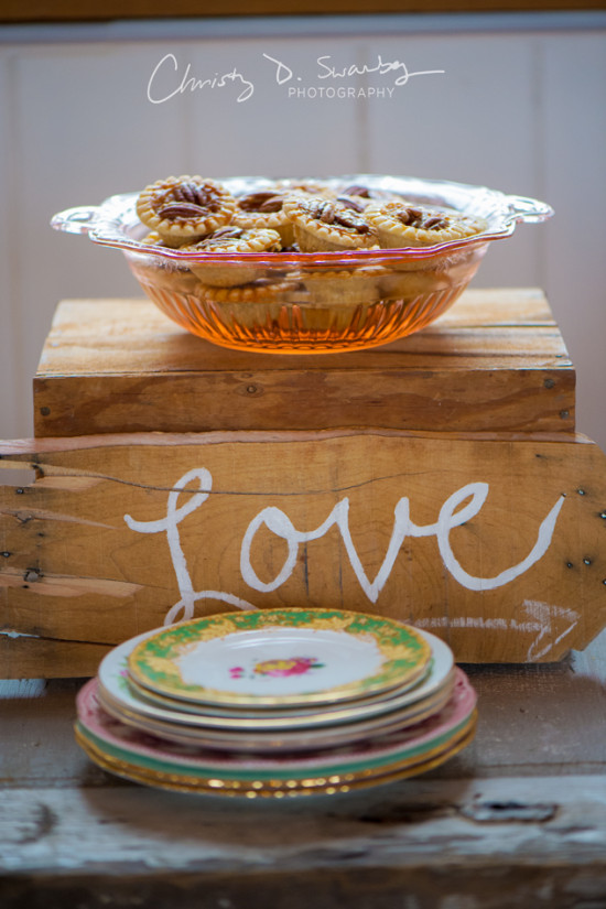 Pecan tarts in a glass bowl on a wooden Love background