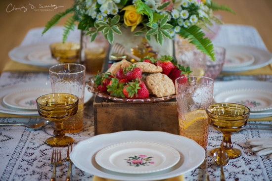 Beautifully set table with fresh strawberries and floral centerpiece