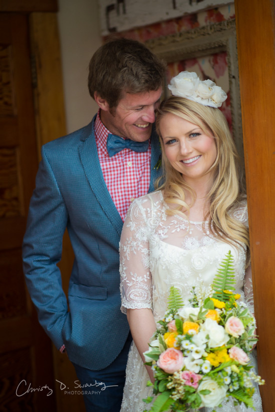 Happy couple on their wedding day, the bride holding a bouquet