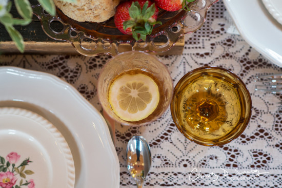 Vintage teatable setting with drinks strawberries and cookies