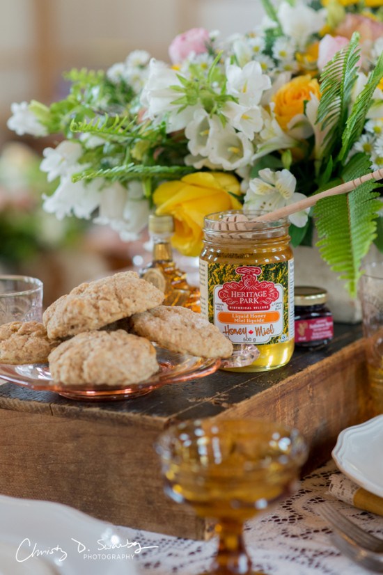 Fresh biscuits honey and flowers on a rustic table