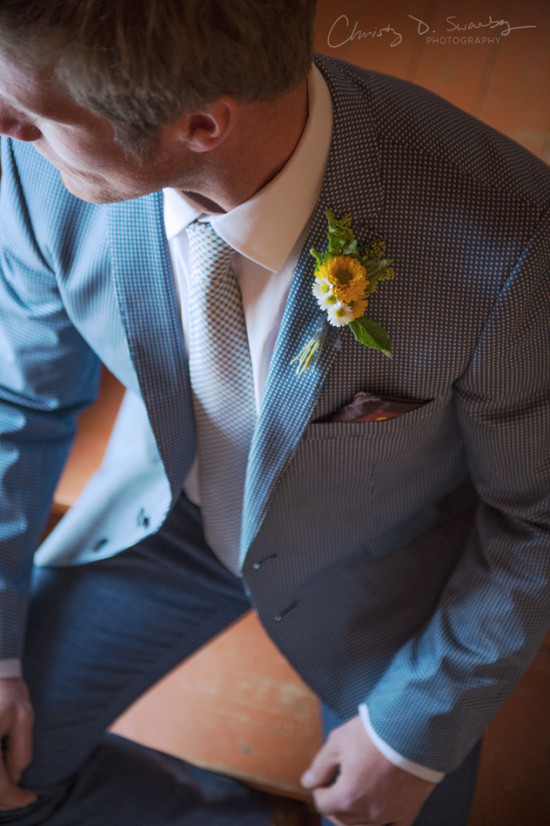 Man in stylish blue suit with flower boutonniere at a wedding