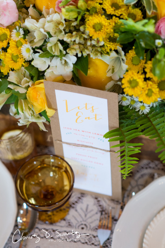 Elegant table setting with flowers and a menu card that says Lets Eat