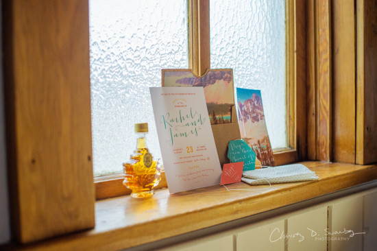 Wedding invitation with a bottle of maple syrup on the window sill
