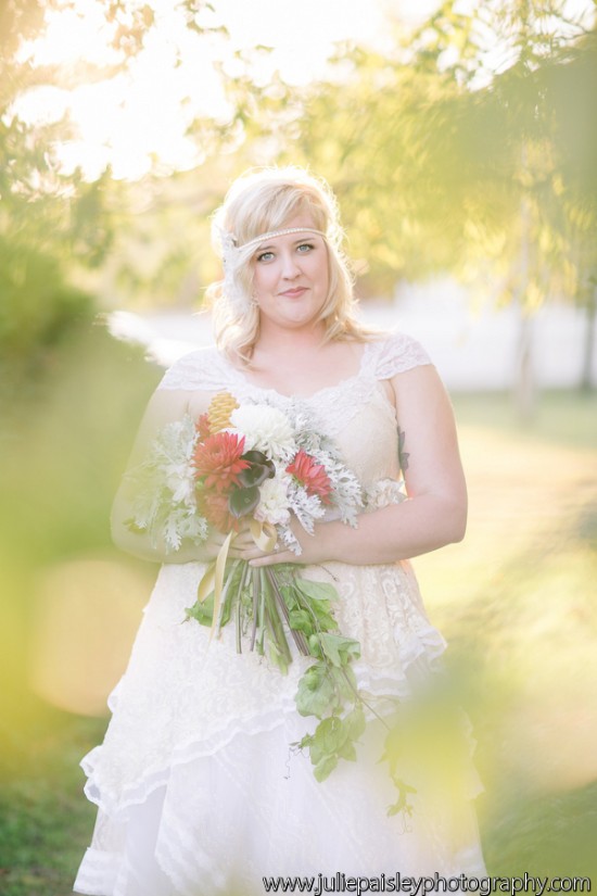Bride in lace dress holding colorful wedding bouquet