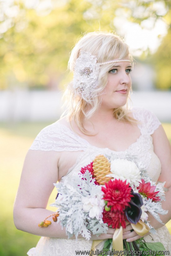 Bride in lace dress with floral headpiece and bouquet
