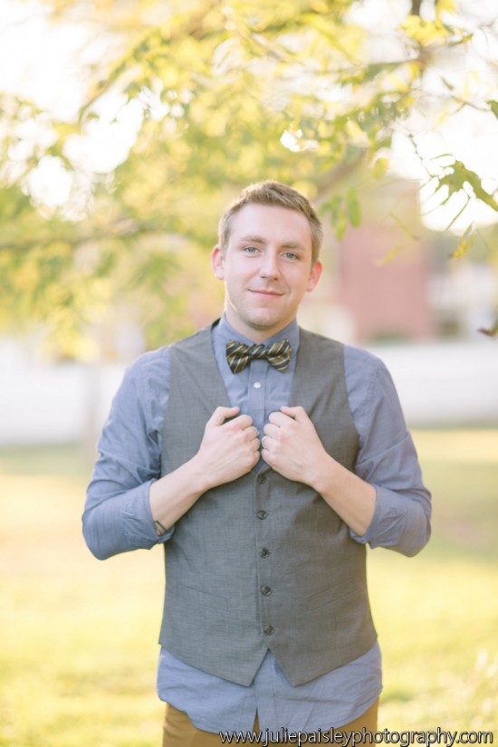 Handsome man in vest and bow tie smiling for portrait photo