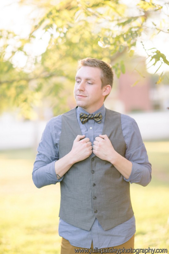 Man in vest and bow tie in a soft, golden light setting