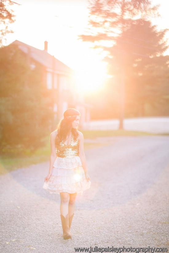 Woman walking on a path, bathed in golden sunset light
