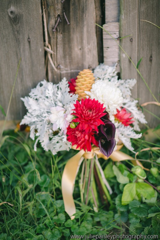 Vibrant red and white bridal bouquet with a golden ribbon