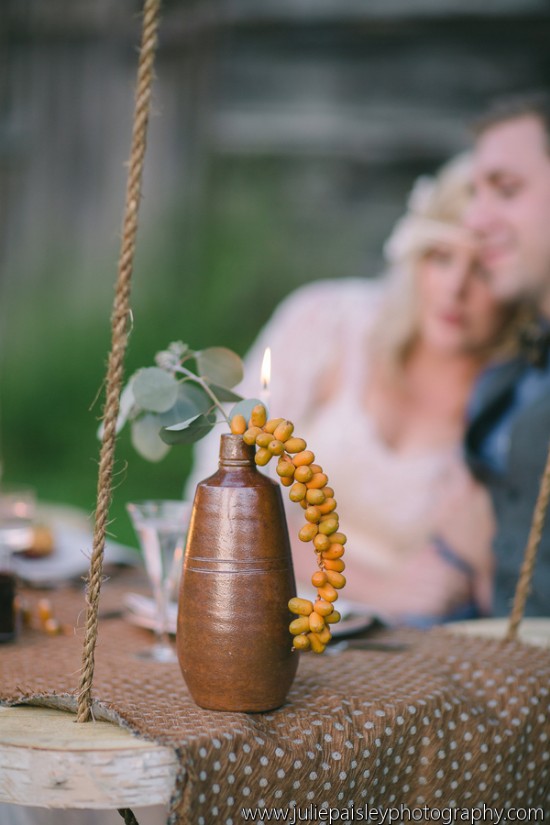 Elegant wedding table decor with a candle and berries