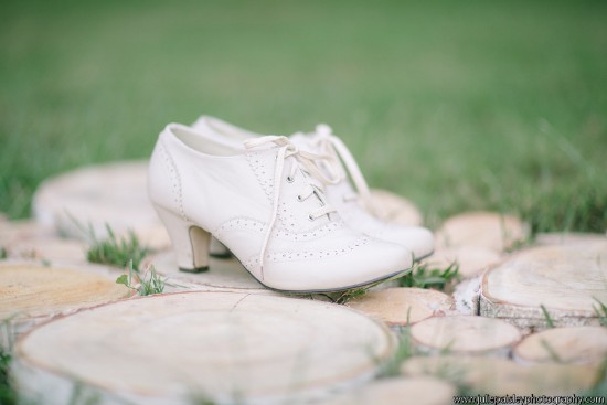 Elegant white vintage heels on wooden slices in a garden setting