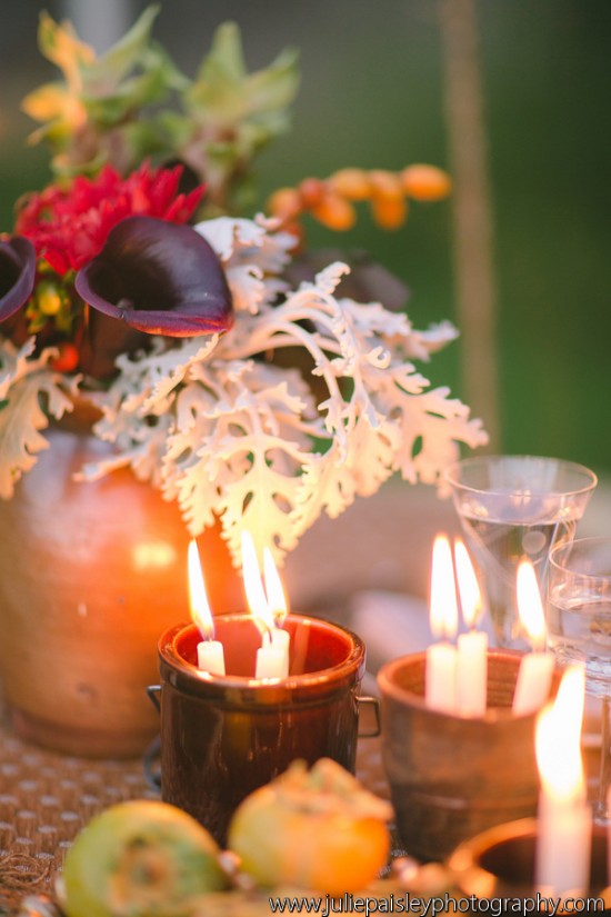 Candles and floral arrangement create a warm, inviting tablescape scene