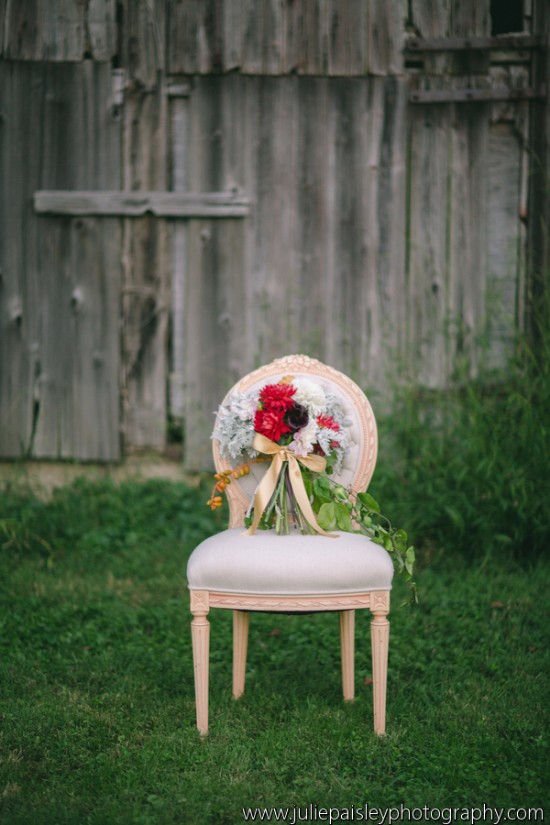 Bouquet on a vintage chair in front of an old wooden wall