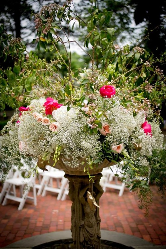Elegant floral arrangement in a stone urn, perfect for weddings