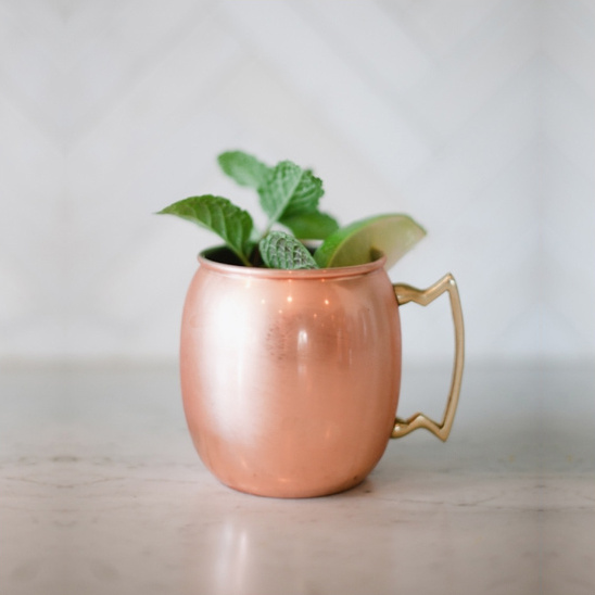 Copper mug Moscow Mule cocktail with mint and lime