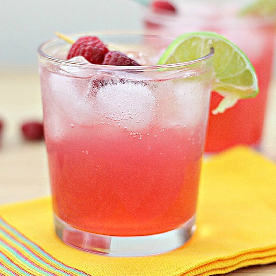 Refreshing pink raspberry cocktail with lime and ice