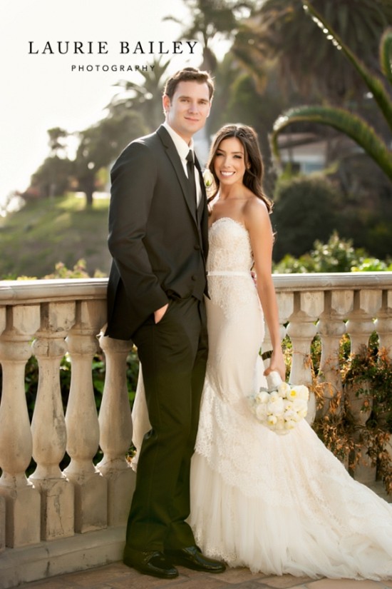 Bride and groom smile for outdoor wedding day portrait