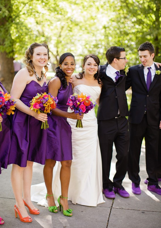 Wedding party with purple dresses and bright bouquets