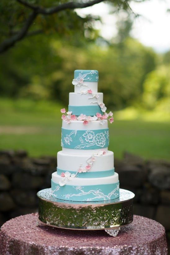blue and white wedding cake with cherry blossoms