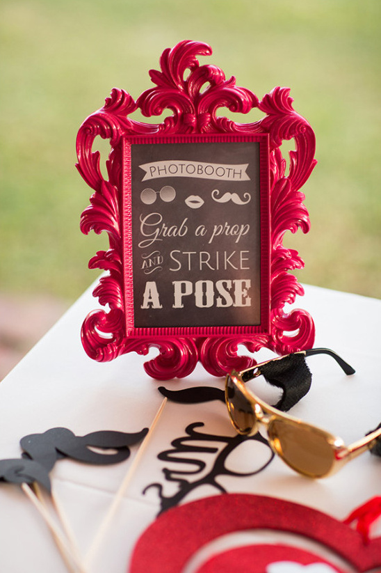 grab a prop and strike a pose photobooth sign
