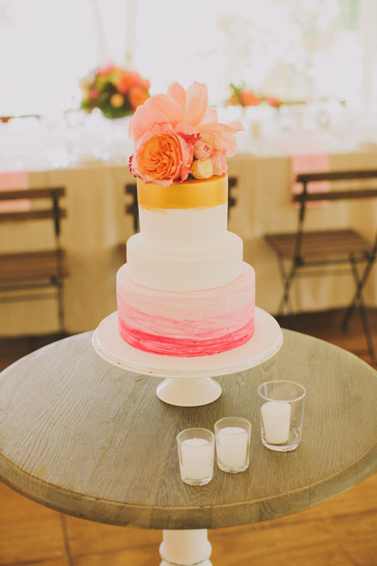 gold and pink floral topped wedding cake