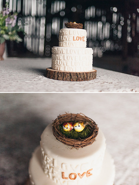 Wedding cake with love theme and bird nest topper