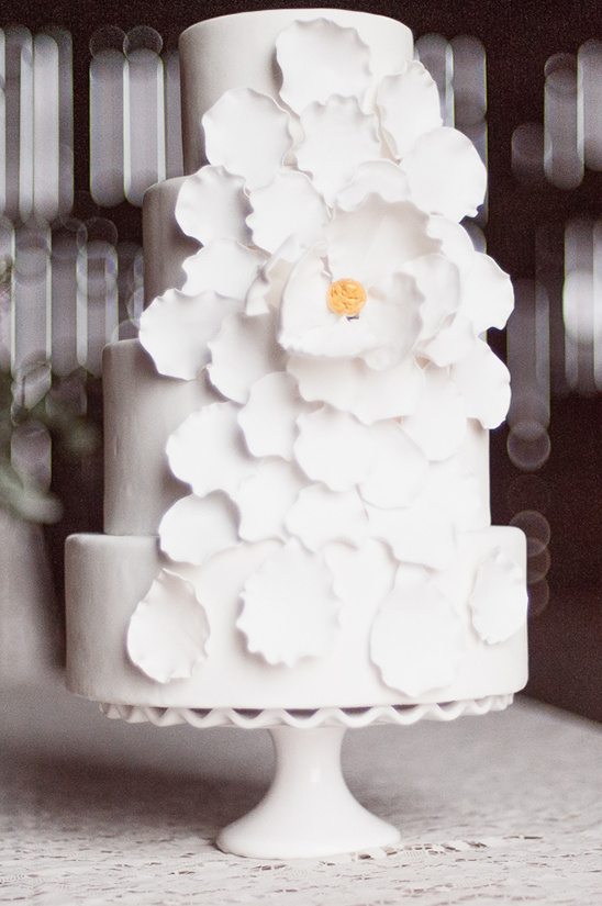 White wedding cake with flower petal decoration