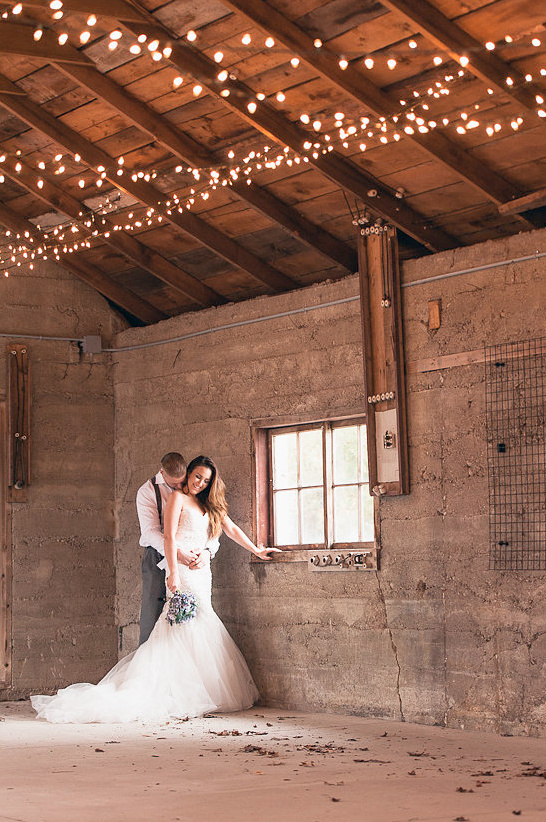 Rustic wedding portrait with string lights above