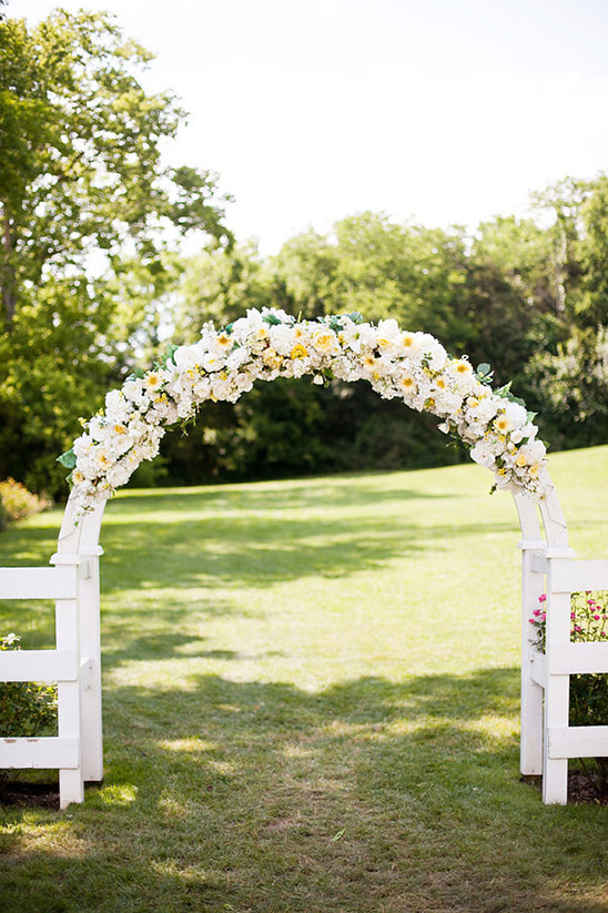 yellow and white floral arch backdrop