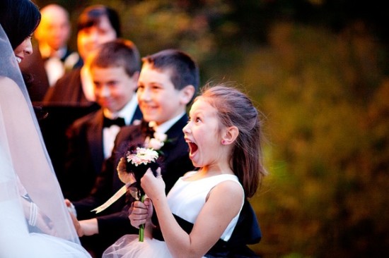 Excited flower girl sees bride at wedding ceremony
