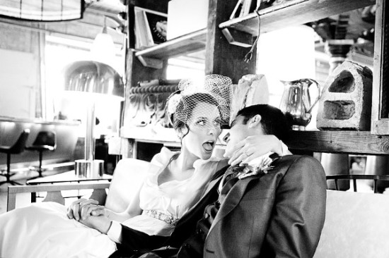Surprised bride with groom in black and white wedding photo