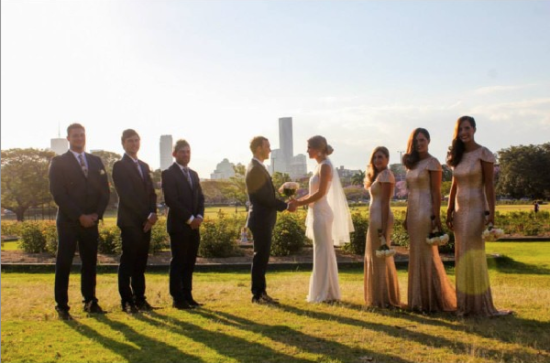 Wedding ceremony in a park with city skyline background