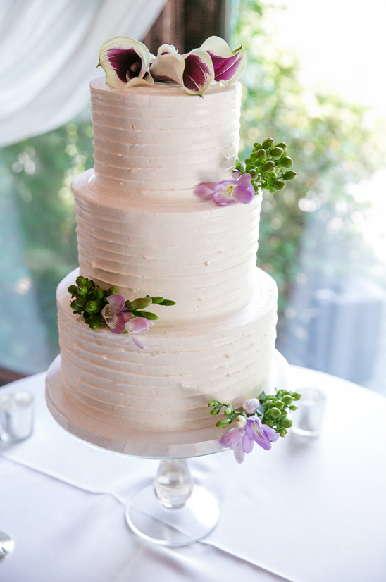 simple tiered wedding cake with floral topper